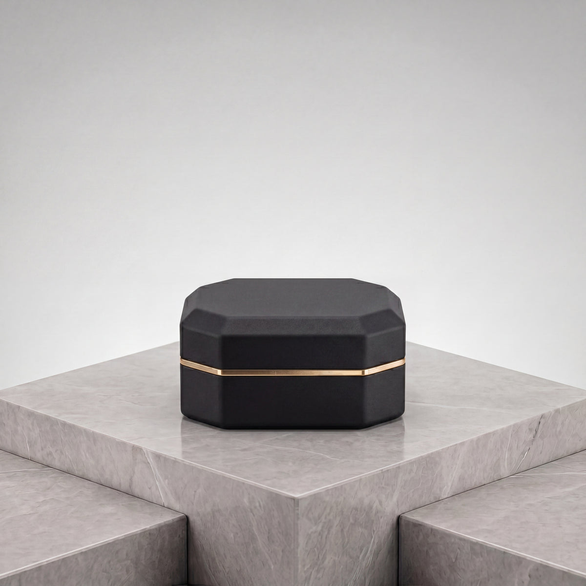 Ormelya Sovereign · octagonal LED ring box in onyx microfibre with antique gold band · closed front view