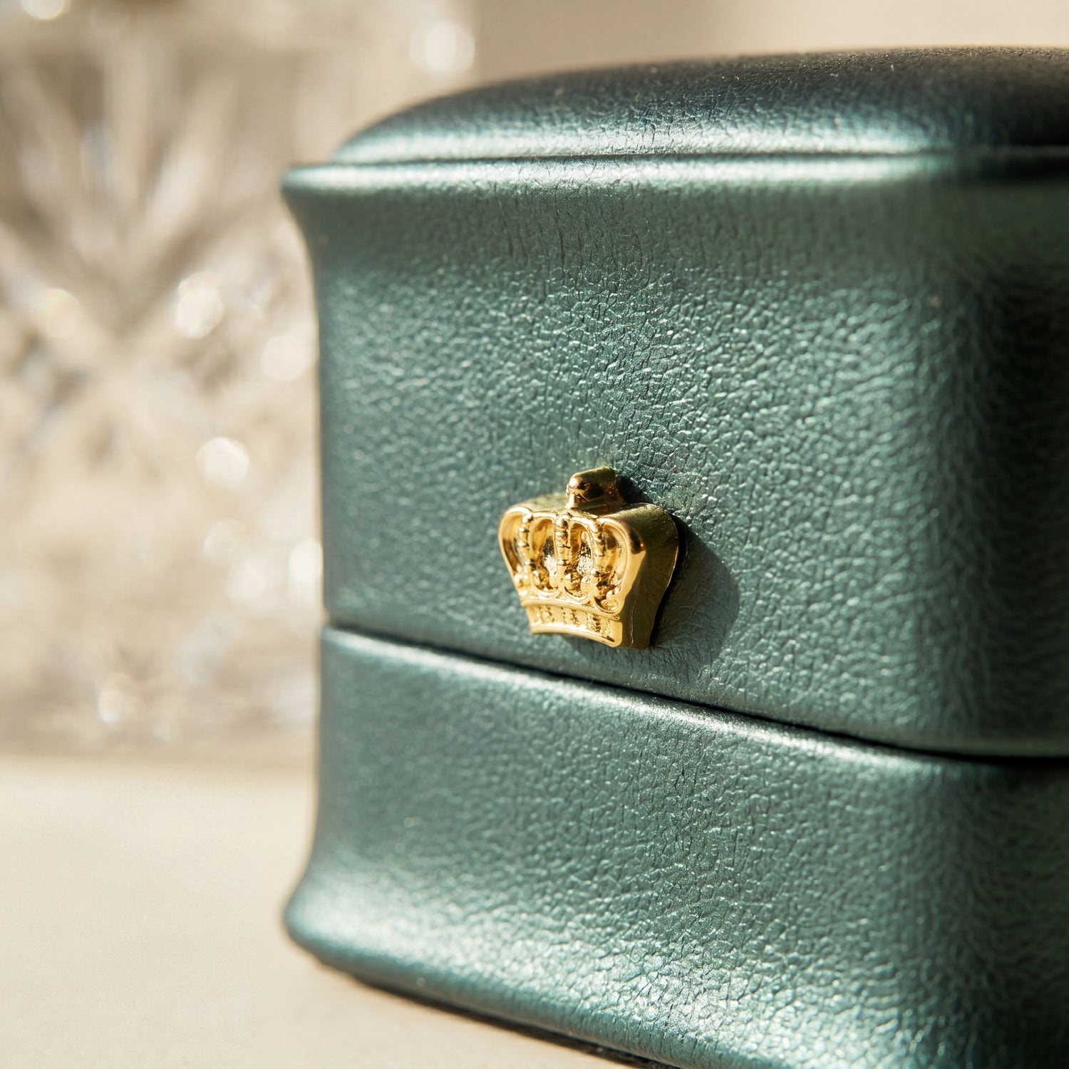 Forest Teal ring box leather texture close-up gold crown detail · Ormelya