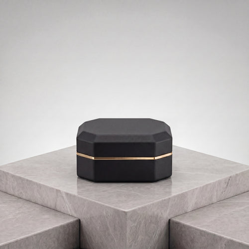 Ormelya Sovereign · octagonal LED ring box in onyx microfibre with antique gold band · closed front view