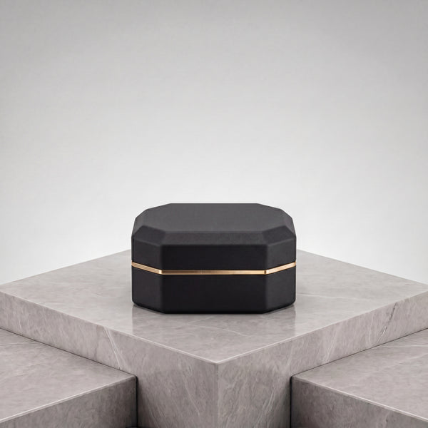 Ormelya Sovereign · octagonal LED ring box in onyx microfibre with antique gold band · closed front view