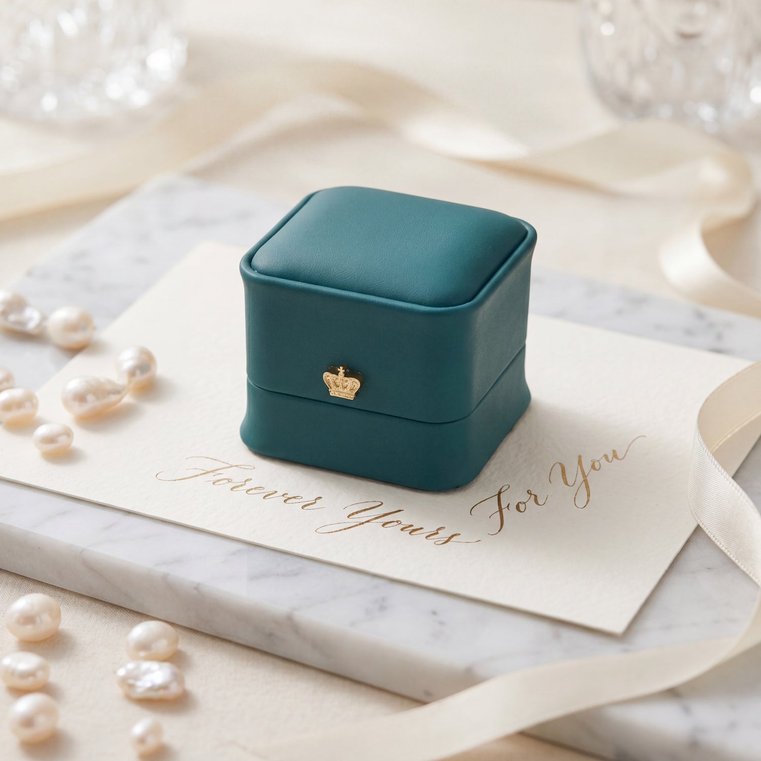 Emerald Green ring box closed on pearls with love card · Ormelya